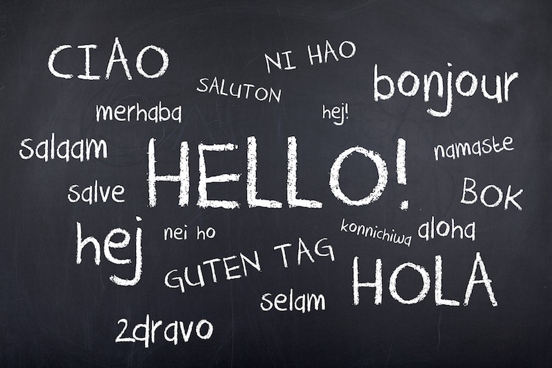 hello written in many languages on chalkboard. benefits of kids being bilingual concept
