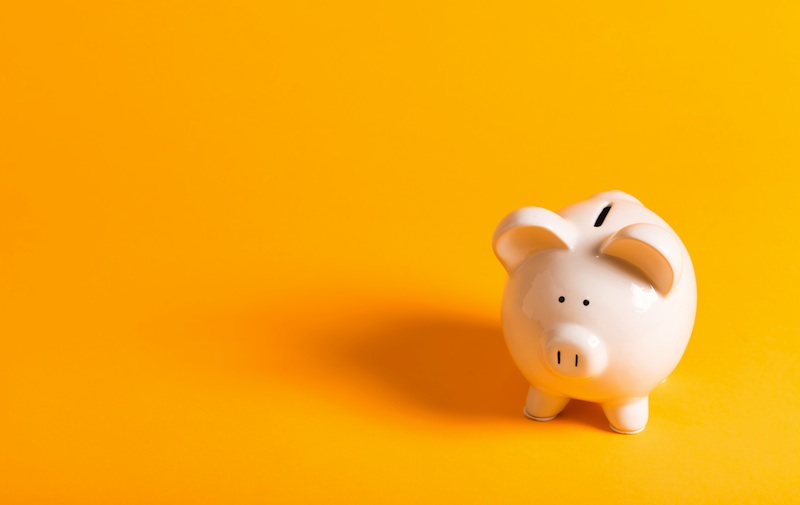 piggy bank on yellow background, for article on being a tps teacher