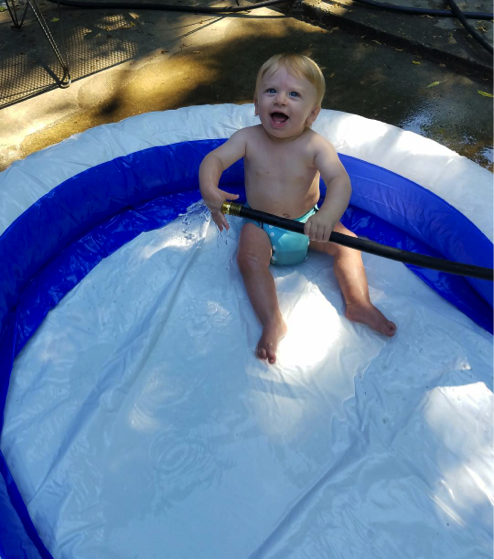 callister sits in a kiddie pool, for article on pool safety for grandparents