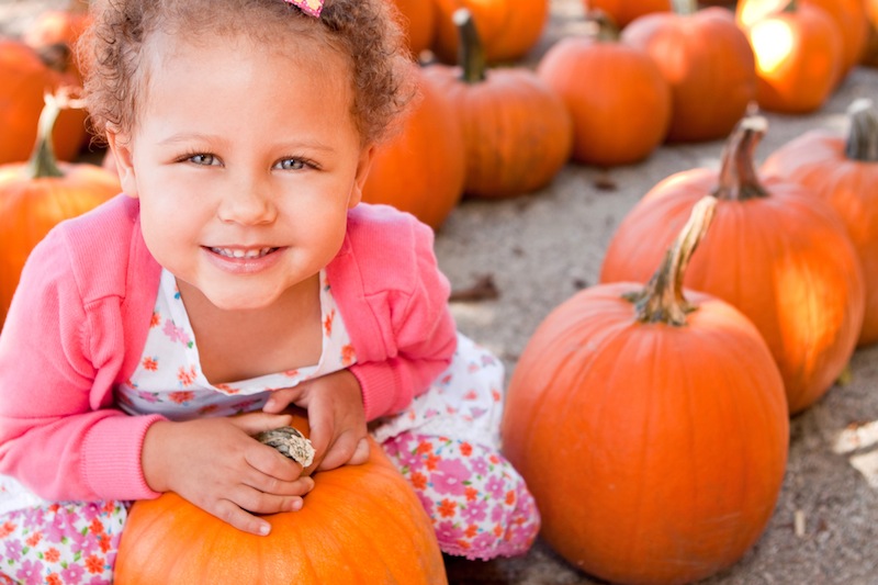 girl with pumpkin, for list of fall festivals in tulsa