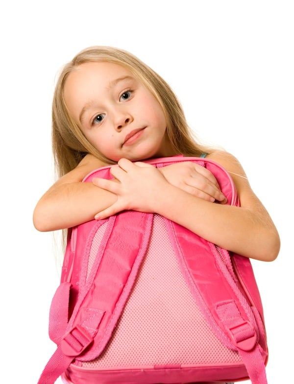 girl looking thoughtful and holding pink backpack, for article on visitations