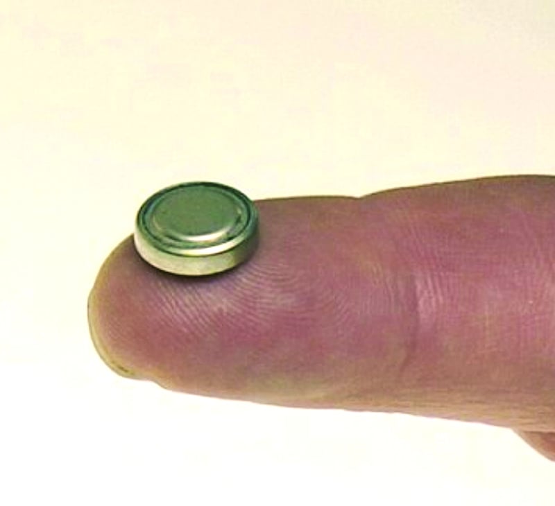 button battery on a finger for article on button batteries