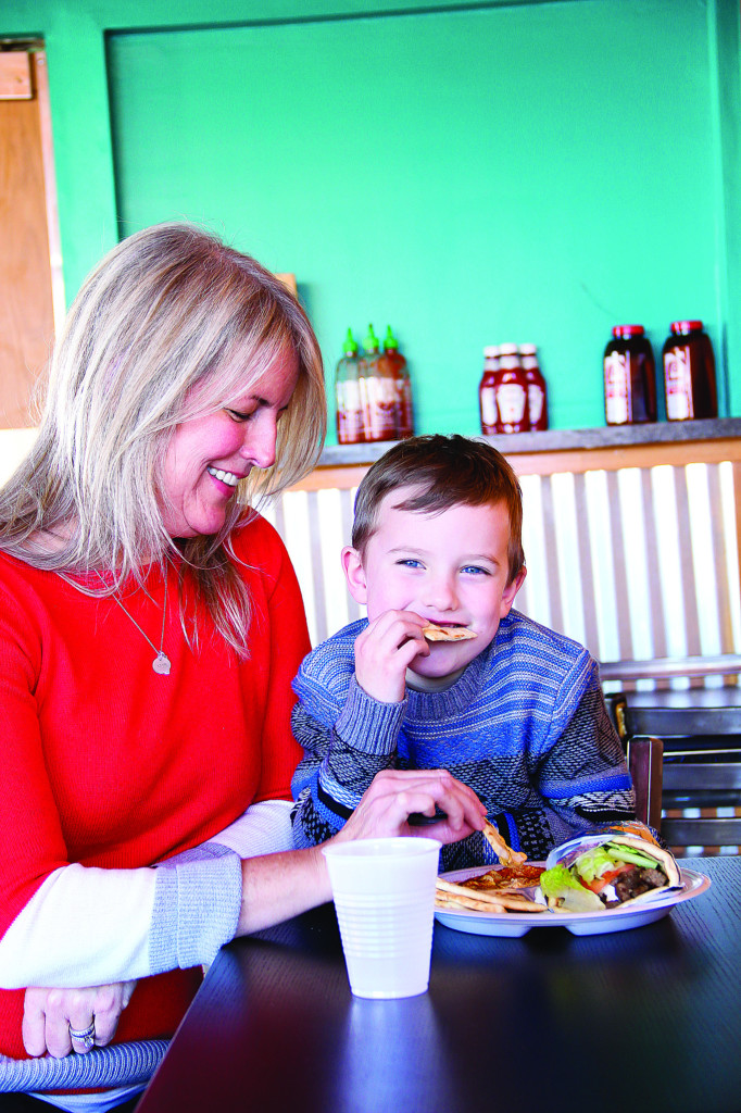 judy allen and a young child. judy is creative director of edible tulsa