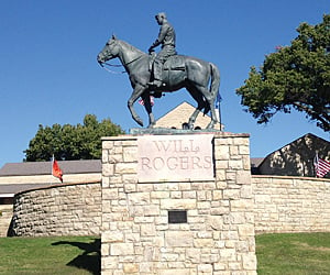 a statue of will rogers on a horse at the will rogers memorial museum