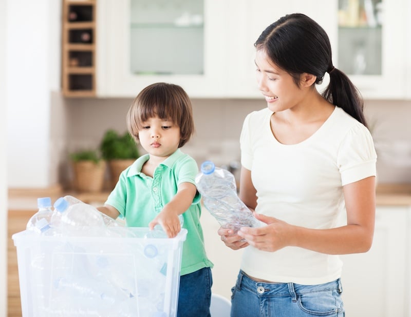 a boy and mom recycling plastic, for article on climate parents group