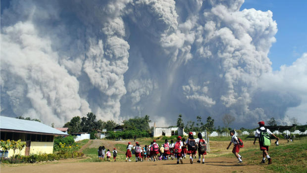 Indonesian schoolchildren walk together at Sipandak elementary school in Tiga Pancur village in Karo