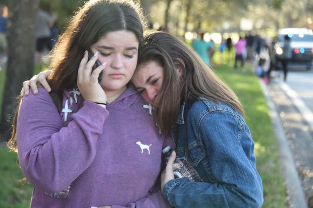 Students react following a shooting at Marjory Stoneman Douglas High School in Parkland