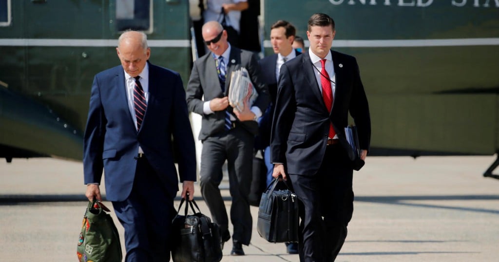 White House Staff Secretary Rob Porter (R) and White House Chief of Staff John Kelly (L) walk to board Air Force One with U.S. President Donald Trump en route to New Jersey from Joint Base Andrews