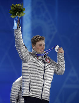 Men's slopestyle skiing silver medalist Gus Kenworthy of the United States smiles while holding his medal during the medals ceremony at the 2014 Winter Olympics