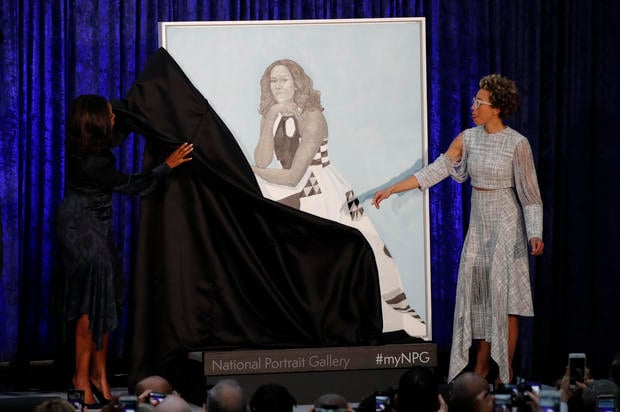 Artist Amy Sherald (R) and former first lady Michelle Obama participate in the unveiling of Mrs. Obama's portrait at the Smithsonians National Portrait Gallery in Washington