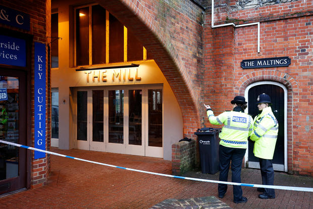 Police officers stand on duty outside a pub which has been secured as part of the investigation into the poisoning of former Russian intelligence agent Sergei Skripal and his daughter Yulia
