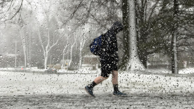 A student walks out of school during the storm in Newtown