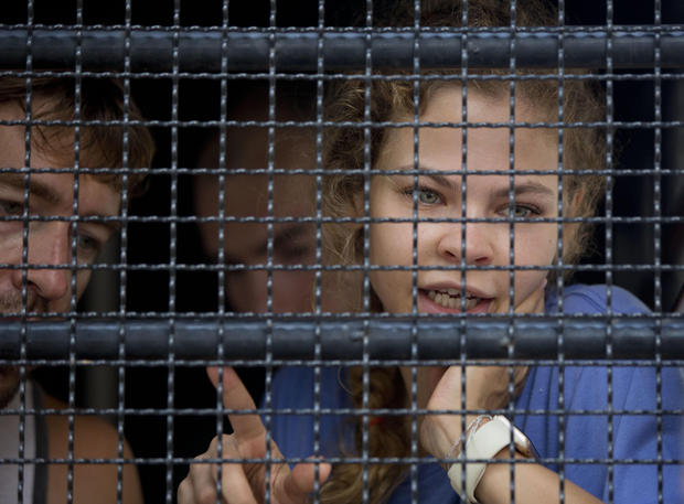 Anastasia Vashukevich talks from inside a police transport vehicle at a detention center in Pattaya