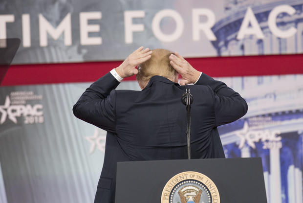 United States President Donald J. Trump adjusts his hair as he speaks at the Conservative Political Action Conference (CPAC) at the Gaylord National Resort and Convention Center in National Harbor