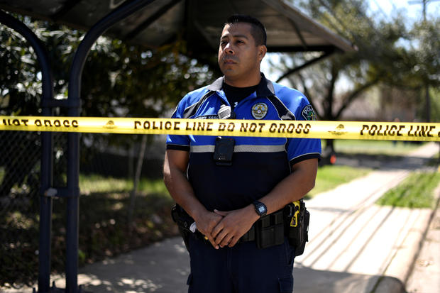 A police officer guards the scene of an explosion on Galindo Street in Austin