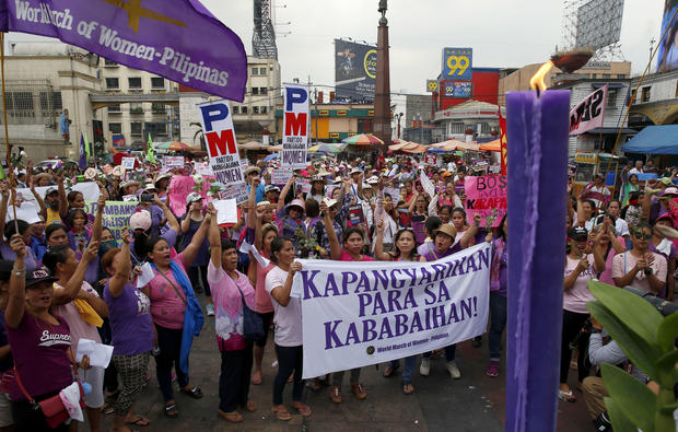 Protesters shout slogans during a rally to mark International Women's Day Thursday