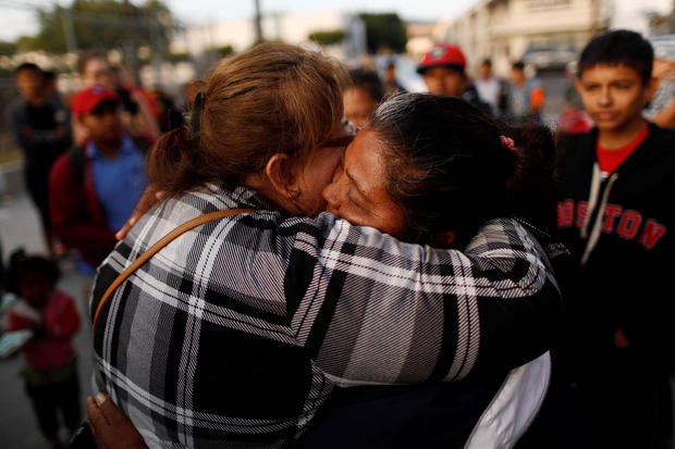 A member of a migrant caravan from Central America hugs an evangelical faithful as they pray in preparation for an asylum request in the U.S.