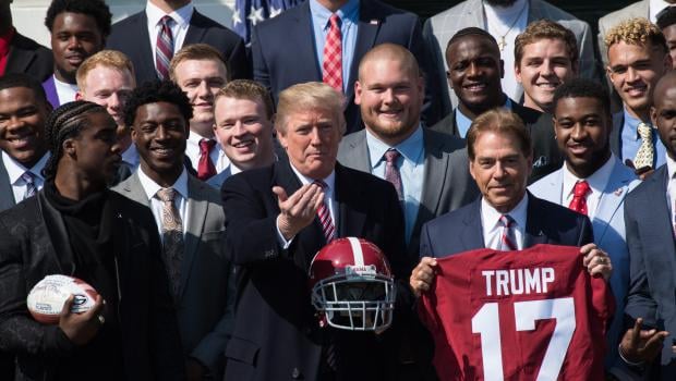 US President Donald Trump poses for photos with the 2017 NCAA football national champions the Alabama Crimson Tide at the White House in Washington