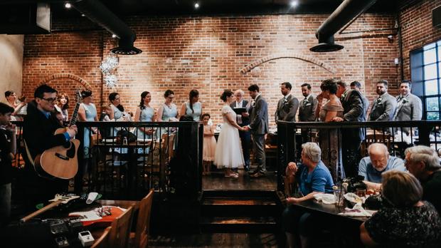 A bride and groom hold hands after floodwaters disrupted their wedding in Ellicott City, Maryland, on May 27, 2018. 