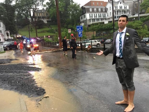 A groomsman poses for the camera after floodwaters disrupted a wedding in Ellicott City, Maryland, on May 27, 2018. 