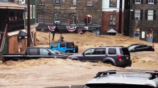 Water rushes through Main Street in Ellicott City