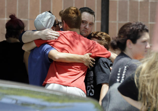People react outside the unification center at the Alamo Gym