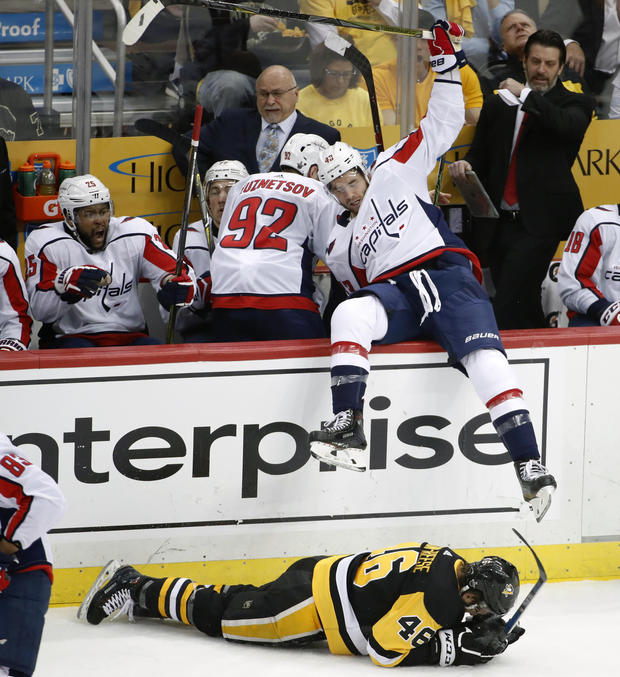 Washington Capitals' Tom Wilson (43) falls over the boards after colliding with Pittsburgh Penguins' Zach Aston-Reese (46) during the second period in Game 3 of an NHL second-round hockey playoff series in Pittsburgh