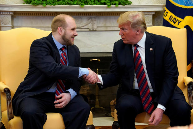 U.S. President Donald Trump shakes hands with Josh Holt