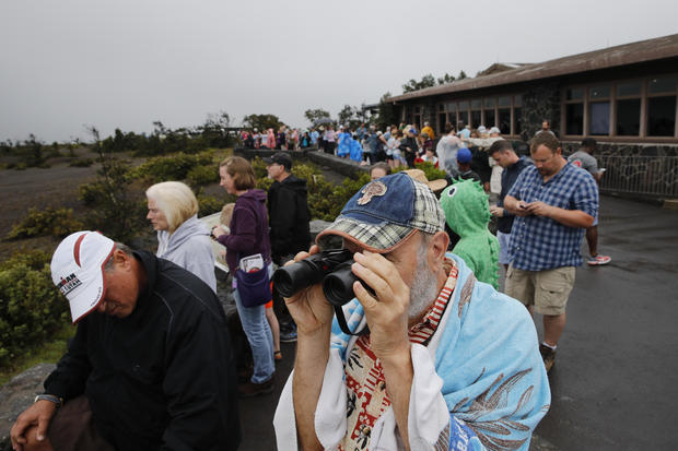 Visitors view Kilauea's summit crater outside the Jaggar Museum in Volcanoes National Park