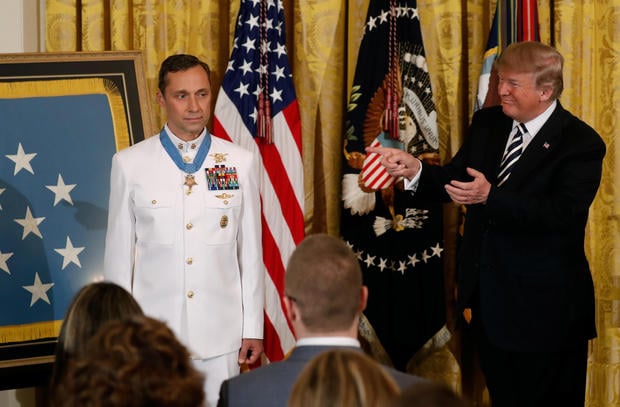 U.S. President Donald Trump gestures after awarding the Medal of Honor to Retired Navy Master Chief Special Warfare Operator (Sea