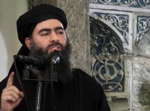 A still photo from video posted on a militant website July 5, 2014, purports to show the leader of the Islamic State of Iraq and Syria, Abu Bakr al-Baghdadi, delivering a sermon at a mosque in Iraq during his first public appearance. 