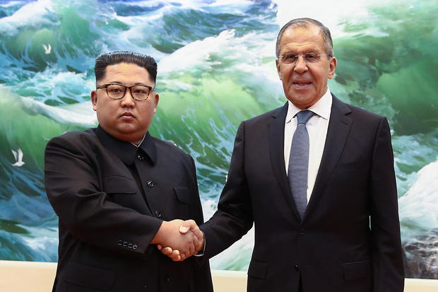 Russian Foreign Minister Sergei Lavrov (R) shakes hands with North Korean leader Kim Jong Un during a meeting in Pyongyang on May 31