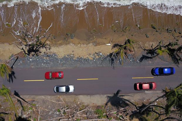 Cars drive on a recently repaired road after Hurricane Maria destroyed one of the most important roads of the area six months after the hurricane affected the island in Humacao