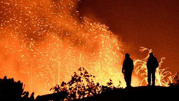 Firefighters keep watch on the Thomas wildfire in the hills and canyons outside Montecito