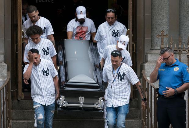 The body of of Lesandro Guzman-Feliz is taken from the Our Lady of Mount Carmel church after funeral services on June 27
