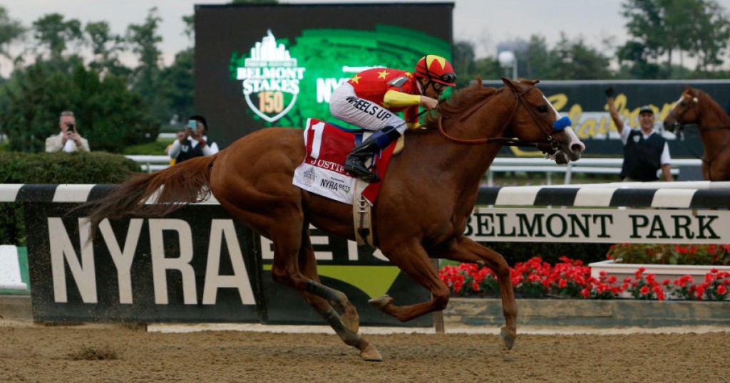 crosses the finish line to win the 150th running of the Belmont Stakes at Belmont Park on June 9