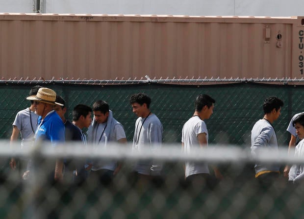 Migrant children walk outside at the Homestead Temporary Shelter for Unaccompanied Children a former Job Corps site that now houses them