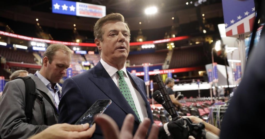 Trump Campaign Chairman Paul Manafort is surrounded by reporters on the floor of the Republican National Convention at Quicken Loans Arena