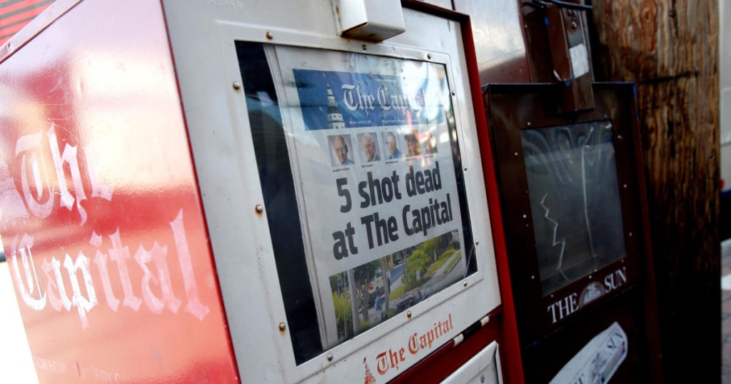 A copy of the Capital Gazette is displayed in a newspaper box the day after a gunman killed five people and injuring several others at the publication's offices in Annapolis
