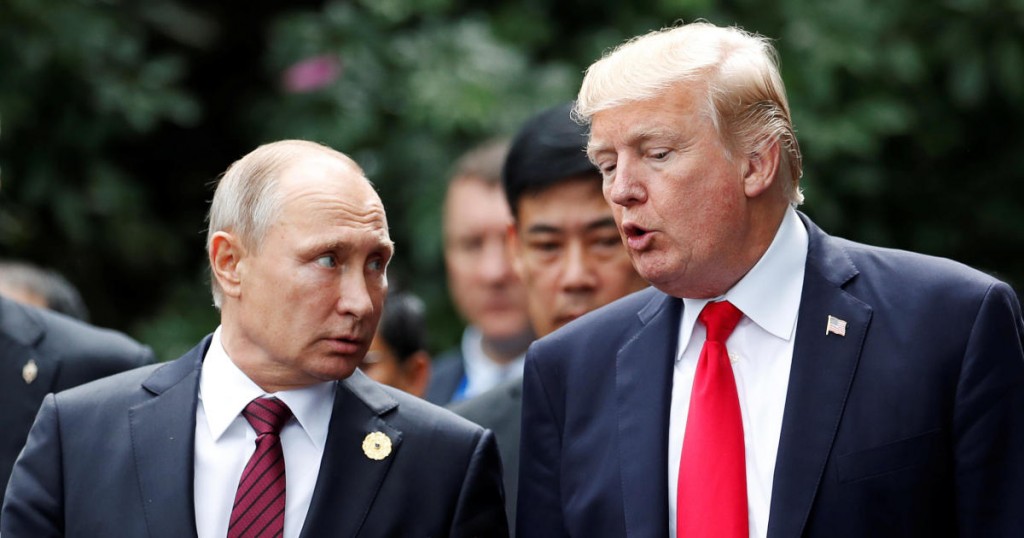 U.S. President Donald Trump and Russia's President Vladimir Putin talk during the family photo session at the APEC Summit in Danang