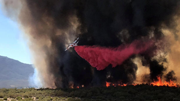 An air tanker drops retardant on wildfire called "BentonFire" near off Benton Road and Crams Corner Drive in this image on social media in Anza in Riverside County