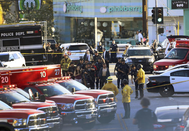 Los Angeles Police SWAT officers escort a group of Trader Joe's supermarket employees