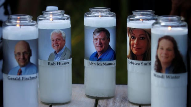 Candles representing the slain journalists of Capital Gazette sit on display during a candlelight vigil held near the Capital Gazette