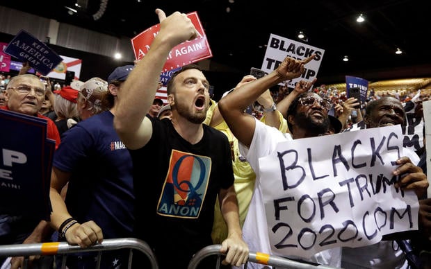 Supporters of President Donald Trump shout down a CNN news crew before a rally Tuesday