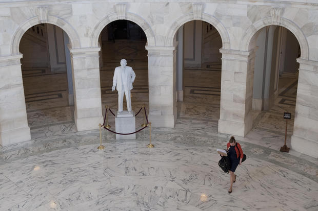UNITED STATES - November 26 : With the exception of a few lone staffers the only thing arriving early on Capitol Hill was the Christmas tree as the fiscal cliff looms. Here a staffer makes her way through the rotunda of the Russell Senate Office Building past the statue of Richard Brevard Russell