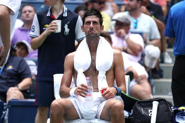 Novak Djokovic of Serbia takes a break from the heat while playing against Marton Fucsovics of Hungary during their Day 2 2018 US Open Men's Singles match at the USTA Billie Jean King National Tennis Center in New York on August 28