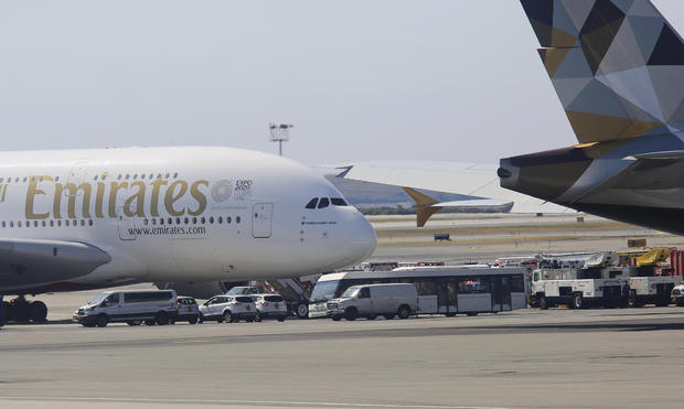 Emergency response crews gather outside a plane at JFK Airport amid reports of ill passengers aboard a flight from Dubai on Wednesday Sept. 5