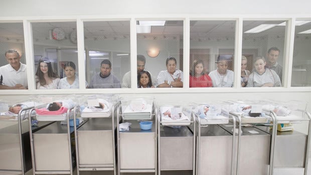 AEB2WR New parents watching babies in hospital nursery