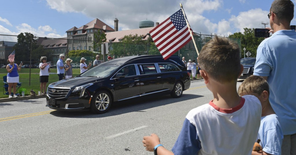 People watch as the casket of Sen. John McCain