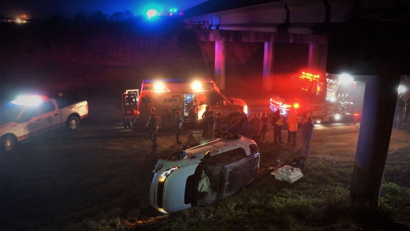 Five passengers escaped their SUV after it went over the I-10 overpass. (Photo source: Pat Sullivan)